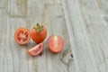 Fresh Tomatoes cut half on wooden background, decorate Royalty Free Stock Photo