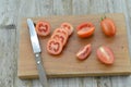 Fresh Tomatoes cut slices in board on wooden background Royalty Free Stock Photo