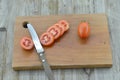 Fresh Tomatoes cut slices in board on wooden background Royalty Free Stock Photo