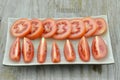 Fresh Tomatoes cut slices in plate on wooden background Royalty Free Stock Photo