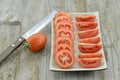 Fresh Tomatoes cut slices in plate on wooden background Royalty Free Stock Photo