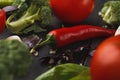 Fresh tomatoes and garlic closeup on dark rustic wood Royalty Free Stock Photo