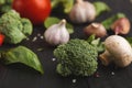 Fresh tomatoes and garlic closeup on dark rustic wood Royalty Free Stock Photo