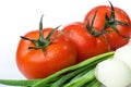 Fresh tomatoes with green onion, close up shot, isolated on white background. Gourmet food or healthy eating Royalty Free Stock Photo