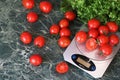 Fresh tomatoes on kitchen scales weighing Royalty Free Stock Photo