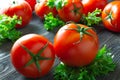 Fresh tomatoes and lettuce on dark wooden table