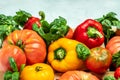 Fresh tomatoes, sweet peppers and basil on white table. Healthy food. Gardening. place for text, top view Royalty Free Stock Photo