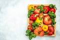 fresh tomatoes, sweet peppers and basil on white table. Healthy food. Gardening. place for text, top view Royalty Free Stock Photo