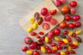 Fresh tomatoes of various colors, sizes, varieties on a wooden floor Royalty Free Stock Photo