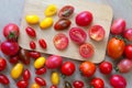 Fresh tomatoes of various colors, sizes, varieties on a wooden floor Royalty Free Stock Photo