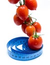 Fresh tomatoes on vine healthy diet concept with tape measure Royalty Free Stock Photo