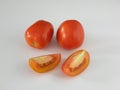 The fresh tomatoes in white background from side view.