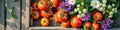 Fresh tomatoes and wildflowers in rustic wooden box on sunny day Royalty Free Stock Photo