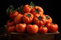Fresh tomatoes on wooden crate against black background