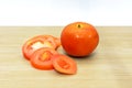 Fresh tomatoes on wooden plate.