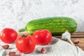 Fresh tomatoes, zucchini and garlic cloves on a napkin Royalty Free Stock Photo