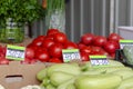 Fresh tomatoes and zucchini with price tags on a street market counter Royalty Free Stock Photo