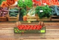 Fresh tomatos in box on wood floor and market background with reflection 3d