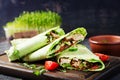 Fresh tortilla wraps with chicken and fresh vegetables on wooden board. Chicken burrito. Royalty Free Stock Photo