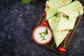 Fresh tortilla wraps with chicken and fresh vegetables on wooden board. Royalty Free Stock Photo