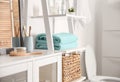 Fresh towels on decorative ladder in bathroom Royalty Free Stock Photo