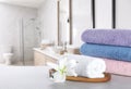 Fresh towels and lily flower on grey marble table in bathroom. Space for text Royalty Free Stock Photo