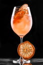 Fresh tropic cocktail with orange and grapefruit in tall glass on black background. Summer drinks and alcoholic cocktails Royalty Free Stock Photo