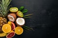 Fresh Tropical Fruits. Pineapple, coconut, kiwi, orange, pomegranate, grapefruit. On a wooden background. Top view. Royalty Free Stock Photo