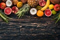 Fresh Tropical Fruits. Pineapple, coconut, kiwi, orange, pomegranate, grapefruit. On a wooden background. Royalty Free Stock Photo