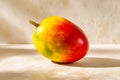 Fresh tropical mango with vibrant color variations on a neutral background Royalty Free Stock Photo