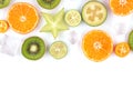 Fresh tropical slices of fruits isolated on white background. Juicy oranges, kiwis, carambolas and ice. Royalty Free Stock Photo