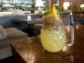 Fresh tropical yellow non-alcoholic cocktail with chia seeds in a mason jar