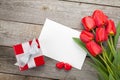 Fresh tulips, gift box and greeting card Royalty Free Stock Photo