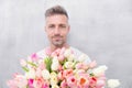 Fresh tulips. Giving her all best. Valentines day and anniversary. How to be romantic. Romantic gentleman. Man mature Royalty Free Stock Photo