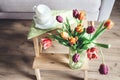 Fresh tulips in vase cozy home spring decoration