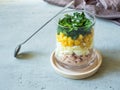 Fresh tuna salad with egg corn greens in a glass Cup on a concrete table. copy space Royalty Free Stock Photo