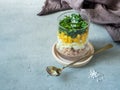 Fresh tuna salad with egg corn greens in a glass Cup on a concrete table. copy space Royalty Free Stock Photo