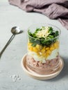 Fresh tuna salad with egg corn greens in a glass Cup on a concrete table. copy space Royalty Free Stock Photo