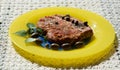 Fresh tuna served with olives, kappar on yellow plate Royalty Free Stock Photo