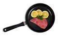 Fresh tuna steak with slices of lemons in skillet. Royalty Free Stock Photo