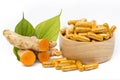 Fresh turmeric and turmeric powder in capsules, Thai herbs.