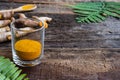 Fresh turmeric and powder curcumin on old wooden background Royalty Free Stock Photo