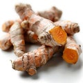 Fresh turmeric root placed on a white background. The brownish outer skin is visible, along with bright orange inner sections Royalty Free Stock Photo