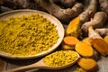 Fresh turmeric roots with turmeric powder Royalty Free Stock Photo