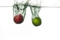 Fresh two apples falling into water