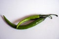 Fresh two green chilies with white background