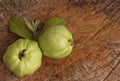 Fresh two Guava fruit and leaf on wooden background. Royalty Free Stock Photo