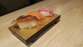 Fresh Unagi, salmon, and tuna nigiri sushi on a wooden platter Royalty Free Stock Photo