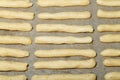 Fresh unbaked cheese sticks on a baking paper for background