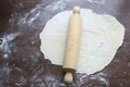 Fresh unbaked dough with rolling pin